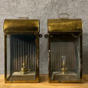A pair of Victorian brass ship's cabin lanterns each having an arched top over a glazed front and