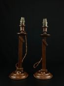 A pair of unusual C.1900 mahogany table lamps each having an octagonal tasseled pagoda shaped
