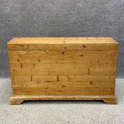 A 20th century pine chest or coffer having an arched lid over a simple carcass raised on shaped