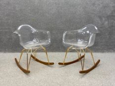 A pair of contemporary Diamond Rock rocking chairs each having a clear moulded polycarbonate seat