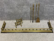A collection of 19th century brass fireside items to include a fender with turned spindles and