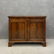A Georgian mahogany collector's or stationery cabinet having a rectangular top hinged to reveal a