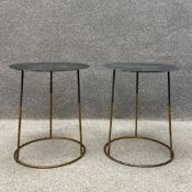 A pair of contemporary side or lamp tables each having a circular sheet metal top raised on a
