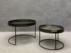 A pair of contemporary nesting side tables each having a circular glass tray top with a simulated