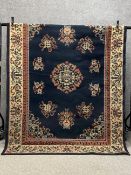 A 1970's Chinese Peking carpet having a central scrolling medallion surrounded by ten others over