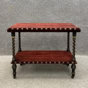 A late 19th century two tier buffet having a square top with a bevelled edge covered in an oxblood