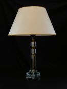 A 20th century Art Deco style glass table lamp having a faceted column form stem with brass