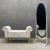 A contemporary window seat with scrolled sides upholstered in an off white calico raised on circular