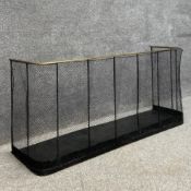 A late 19th century Victorian nursery fire guard having a bent brass top rail over a meshwork screen
