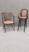 A 19th century ebonised bentwood and rattan high chair in the manner of Thonet along with a 20th