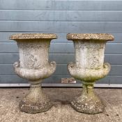 A pair of 19th century style reconstituted stone campana form urns each having a wide flared rim