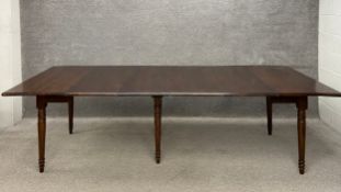 A 19th century mahogany extending concertina dining table having a rectangular top raised on six