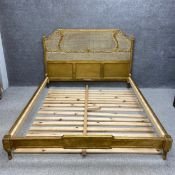 A Louis XVI style French giltwood and rattan super kingsize bed having a Neoclassical style