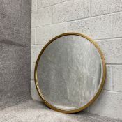 A contemporary circular wall mirror with a bevelled plate in a gilt surround. H.80 W.80cm