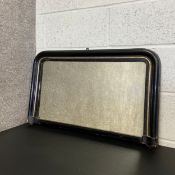 A late 19th century overmantel mirror having an arched lacquered frame with a gilt trim