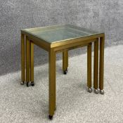 A nest of three mid to late 20th century graduating side tables each having a plate glass top