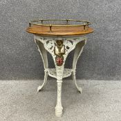 A Victorian painted cast iron Britannia pub table having a circular thumb moulded oak top with a