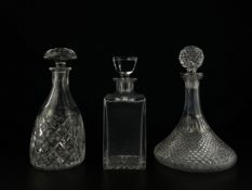 A collection of three 19th century and later cut glass decanters with stoppers. H.26.5cm