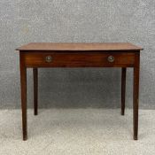A Georgian mahogany side table having a rectangular top over a single frieze drawer raised on