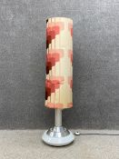 A mid century floor lamp having central circular chrome stem raised on concentric bands of chrome