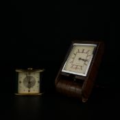 Two Art Deco travel clocks to include a Jaeger eight day Swiss Memovox alarm clock with a brushed