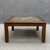 A 20th century Oriental style teak coffee table having a square rattan top inset with protective