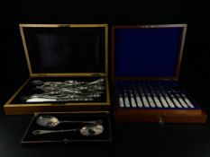 Three sets of cutlery to include an early 19th century hallmarked silver mounted mother of pearl six