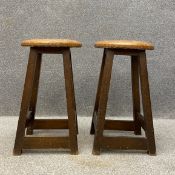 A pair of 20th century high stools each having a circular top raised on square splayed stretchered