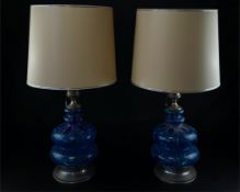 A pair of contemporary Eastern style table lamps each having a pierced metal finial light fitting