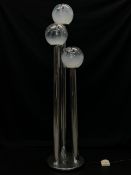 A 1970's Italian floor lamp having three moulded spherical (possibly Murano) glass shades raised