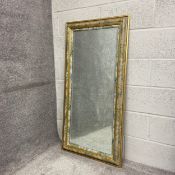 A contemporary wall mirror having a rectangular bevelled plate within a printed floral and gilt
