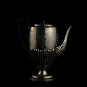 An early to mid 20th century hallmarked silver coffee pot having a reeded lid over a half reeded