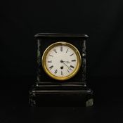 A 19th century French slate mantle clock having a moulded cornice over an enamelled dial bearing