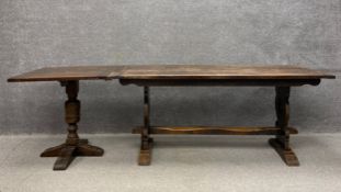 A 20th century oak refectory table having a rectangular three plank top raised on carved openwork