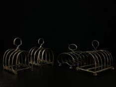 A collection of four early 20th century silver hallmarked toast racks to include a pair by Jay,