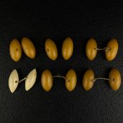 Two pairs and one matched pair of early 20th century amber or phenolic resin cufflinks or beads of