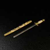 A 20th century to scale miniature Oriental sword with a brass mounted enamelled sheath and handle
