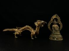 Two Oriental figural statues to include a Chinese Tang style gilt metal dragon and a possibly 18th