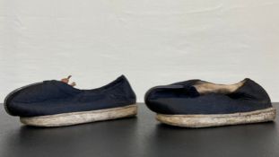 A pair of early 20th century Chinese adult shoes each having a black quilted upper with