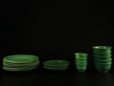 A part set of early 20th century Chinese green Peking glass to include four small tea bowls, five
