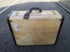 An early 20th century brass and leather mounted ivory coloured travel hard case or trunk with a