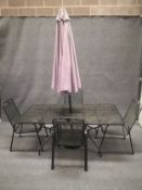 A set of metal garden furniture to include four chairs and a table along with a parasol. H=71cm. W.
