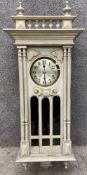 A late 19th/early 20th century carved and painted neoclassical style wall clock with two ball and