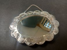 A hallmarked .800 silver repousse miniature mirror profusely decorated with all-over scrolling
