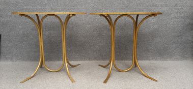 A pair of Art Deco style occasional tables with simulated tortoiseshell oval resin tops on gold