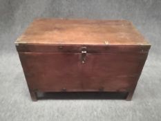 A 19th century camphor trunk or chest with brass straps and corners and iron handles raised on