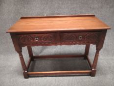 A 20th century oak serving table having a short gallery back on a moulded rectangular top above