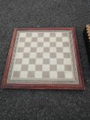 A contemporary resin chess board in a moulded wood surround along with a card box carved and painted