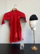 A 20th century traditional Chinese child's box red tunic with a repeating embroidered pattern and
