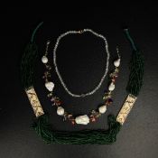 Three pieces of jewellery to include a bead and carved bone necklace, a cut rock crystal necklace